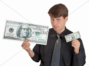 Young man holding large and small money