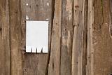 Paper ad on wooden fence