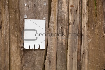 Paper ad on wooden fence