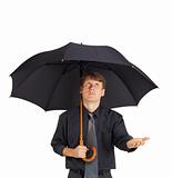 Young man with large black umbrella