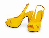 Pair of yellow female shoes isolated on white background