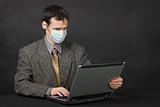 Person with medical mask working in Internet