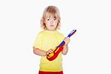 boy with long blond hair playing with toy guitar - isolated on white