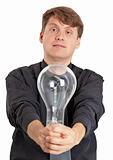 Young man with electric bulb in hands