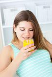 Caucasian young woman drinking orange juice