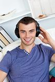 Smiing caucasian man listen to music with headphones 