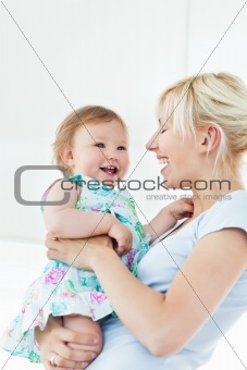 Smiling woman playing with her daughter