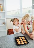 Pretty mother baking cookies with her daughter