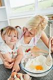 Cute woman baking cookies with her daughter