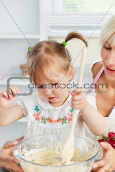Sweet woman baking cookies with her daughter