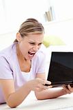 Young woman getting frustrated with a computer at home