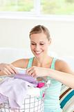 Positive young woman doing the laundry 