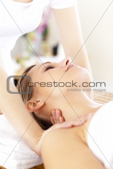 Portrait of a radiant woman having a massage in a spa