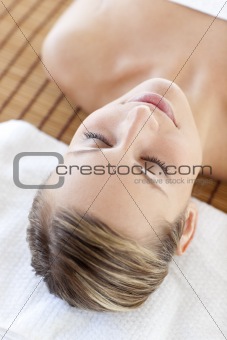 Portrait of a beautiful young woman lying on a massage table