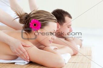 Relaxed young couple receiving a back massage in a Spa center