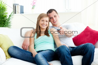  Affectionate man embracing his girlfriend while watching tv 
