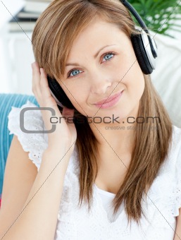 Portrait of a delighted woman listen to music with headphones 
