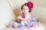 adorable baby-girl with flower and necklace