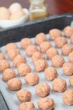 Raw meatballs on baking sheet