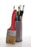 Paintbrushes in a metal mesh holder