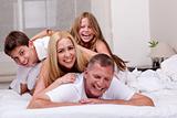 Family having fun in bed