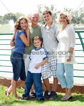 Family posing infront of lake
