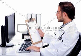 Young ethnic doctor looking at medical report deeply 