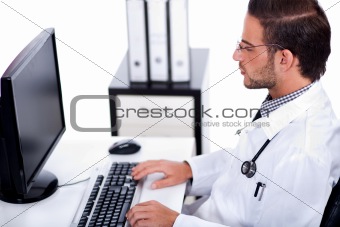 male doctor working with desktop at his desk