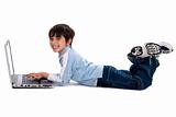 Young boy surfing on his laptop