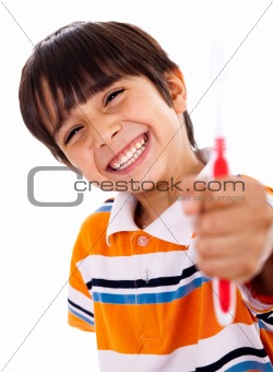 Happy young boy showing the toothbrush