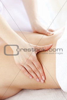 Close-up of a young woman receiving a back massage