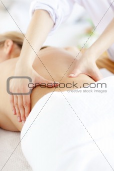 Close-up of a caucasian woman receiving a back massage 