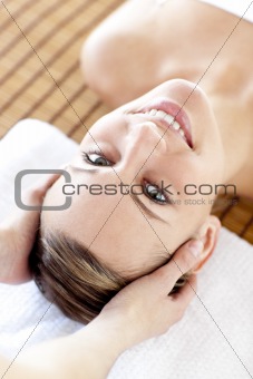 Close-up of a bright woman receiving a head massage in a Spa center