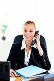 Self-assured businesswoman talking on phone in her office 