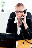 Ambitious businesswoman talking on phone using her laptop 