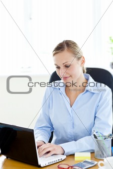 Concentrated caucasian businesswoman using her laptop 