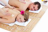 Beautiful young couple receiving a back massage