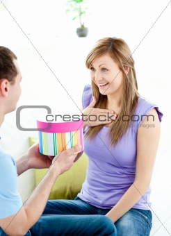 Attractive boyfriend giving a present to his pretty girlfriend 