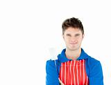 Charming young cook holding a cookware against white background