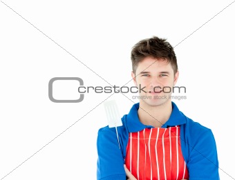 Charming young cook holding a cookware against white background