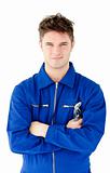 Charismatic mechanic holding tool smiling at the camera 