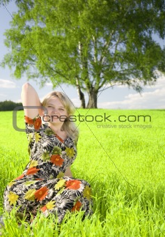 Lovely young girl relaxing on a meadow