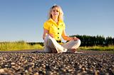 girl meditates on highway middle in rural 