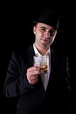 young man with a black hat and a glass of whiskey in his hand