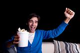 happy young man, with popcorn watching