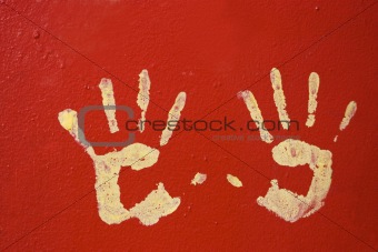 Yellow hands on red wall