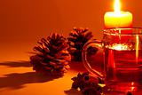 red tea cinnamon sticks star anise conifer cone at candle light