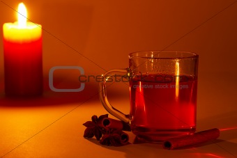 red tea cinnamon sticks star anise at candle light