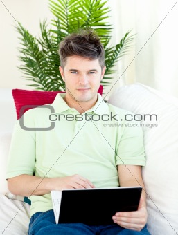 Charming man sitting in front of his laptop against white background