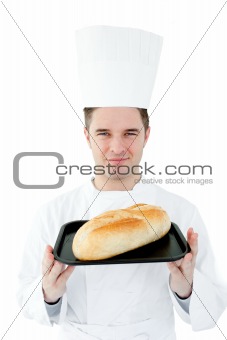 Self-assured chef holding a fresh bread 